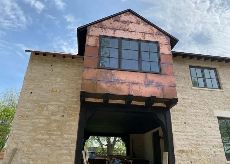 Copper metal panel facade on a stone building for Skylight Installation in Laramie