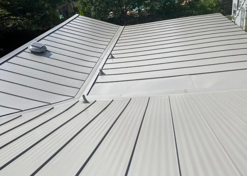 Solar attic fan installed on a metal roof for Roof Ventilation in Laramie